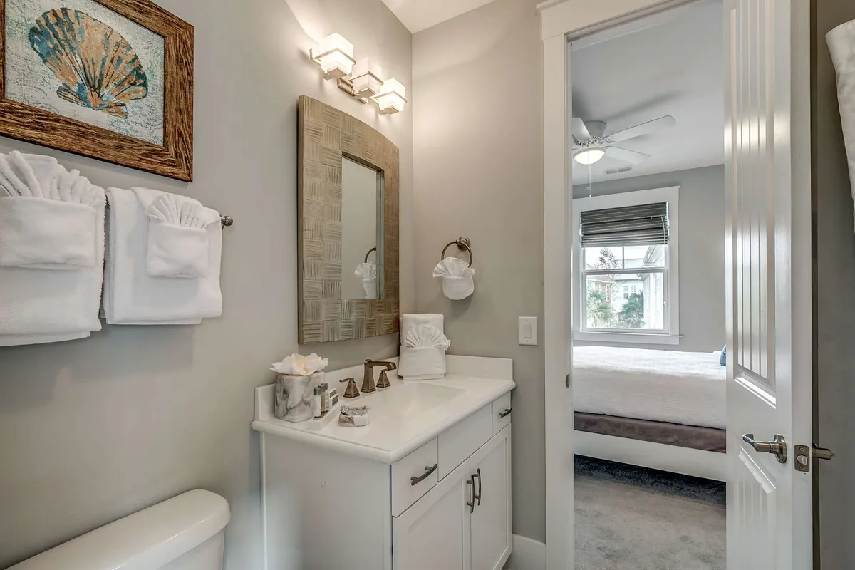 A fresh, clean vanity area with a sink, mirror, and tasteful wall art, set up for grooming and relaxation. The atmosphere is calming and inviting, suggesting a refreshing start or end to the day.