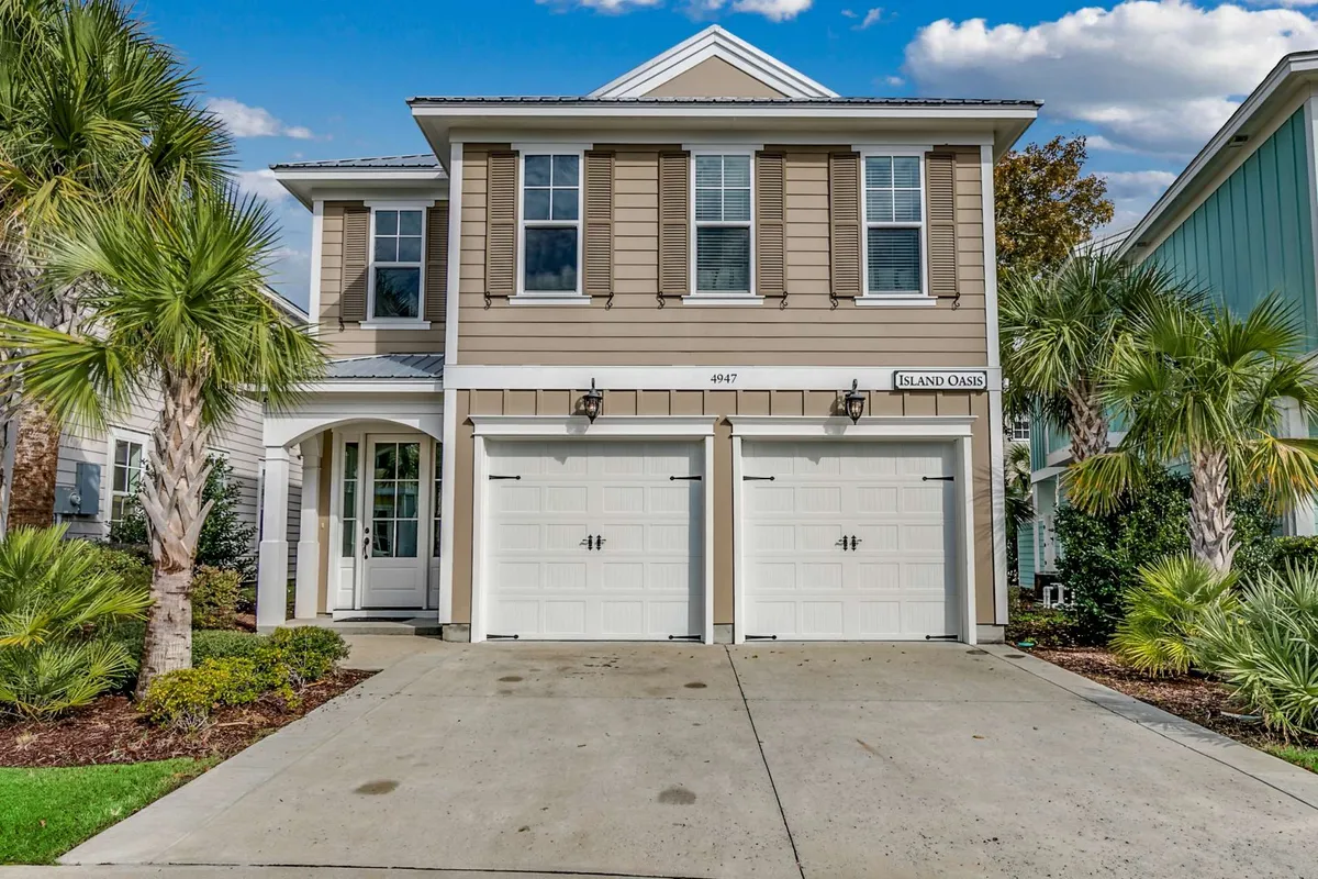 The image showcases the inviting exterior of a spacious single-family house, featuring a grand front entrance, double garage doors, lush landscaped gardens, and swaying palm trees that evoke a relaxed, coastal vibe. The welcoming porch hints at relaxing summer evenings, and the well-kept surroundings suggest a friendly neighborhood ideal for families.